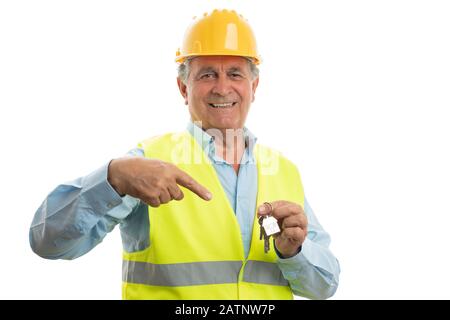 Old male architect pointing index finger at house keys isolated on white studio background Stock Photo