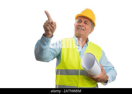 Happy old male architect pointing index finger at blank copyspace with papers isolated on white background Stock Photo