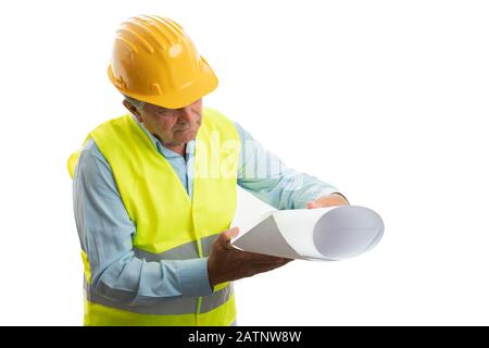 Old male architect having serious expression looking at paper with plans isolated on white studio background Stock Photo