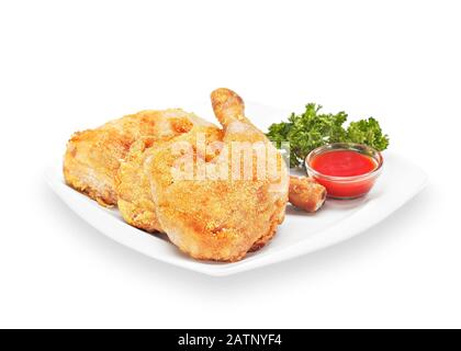 Hot Fried Crispy Chicken drumstick in batter on a white plate with ketchup and lettuce. Breaded Crunchy Meat Made of Chicken Legs. Isolated on white Stock Photo