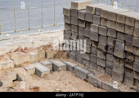 Stack of bricks at a construction site closeup in the sand Stock Photo