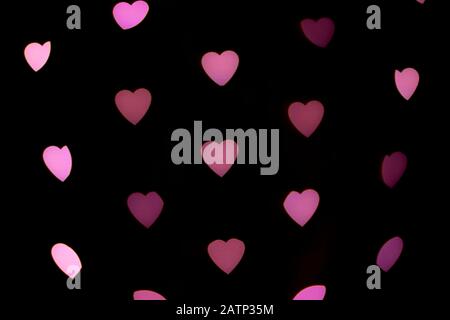 Valentines background. Abstract heart bokeh background. Defocused blurred heart shaped lights.  Love concept. Stock Photo