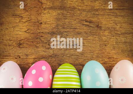 Colorful painted easter eggs in front of an old wooden background Stock Photo
