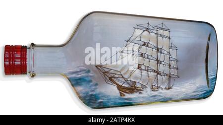 Digitally created image of a tall ship with full sail sailing in a rough sea inside a transparent bottle Stock Photo