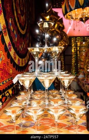 A tower of champagne glasses . A champagne cascade show pyramid of glasses. Stock Photo