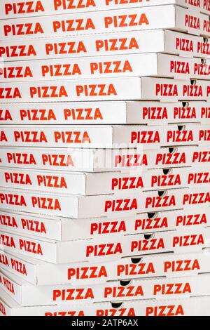 Large vertical stack of new cardboard pizza boxes Stock Photo