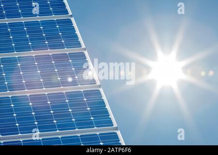 Blue solar panel with a bright sun shining on the right side Stock Photo