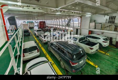 Cars parked on deck of Naviera Austral Quelat ferry, en route in Aysen Region, Patagonia, Chile Stock Photo