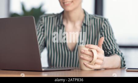 Unrecognizable Businesswoman At Laptop Working Having Coffee In Office, Panorama Stock Photo
