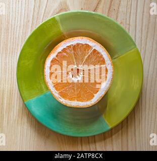 sliced grapefruit on green plate Stock Photo