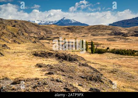 Volcanic rocks in grassland of Chacabuco Valley, future Patagonia National Park, near Cochrane, Chile Stock Photo