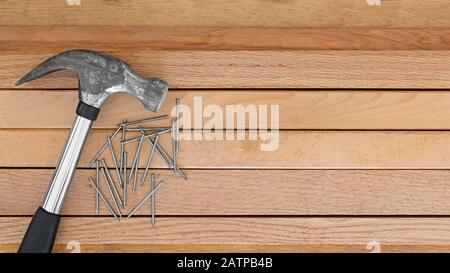 Hammer and nails on wood background Stock Photo