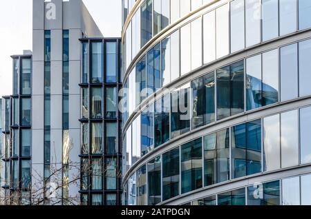 Close up view of detail on a modern glass building with reflective glass and contemporary design. Stock Photo