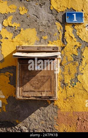 Wooden mailbox with house number one on house wall with flaking paint, Vueltas, Valle Gran Rey, La Gomera, Canary Islands, Spain Stock Photo