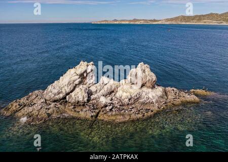 Islets, island in Choyudo beach. stable land area full of guano. Islet is a small island: Cayo, Faralló Islette, Isle, sea water, surrounded, body of Stock Photo