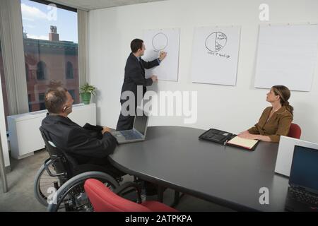 Businessman giving a presentation in an office meeting Stock Photo