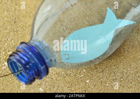 Close-up of fish on a hook in a plastic bottle - Concept of ecology and stop plastic pollution Stock Photo