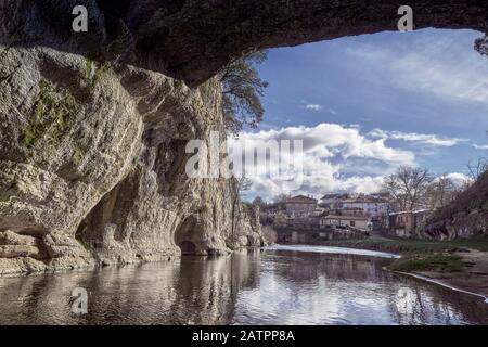 Puentedey with the river Nela and its famous stone bridge surrounded by large rocks in the Merindad de Valdeporres of the province of Burgos, Spain Stock Photo