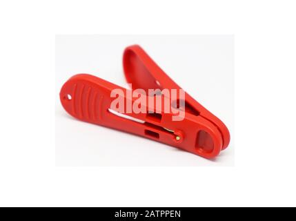 Red plastic clothespins isolated on white background. Plastic clips Stock Photo