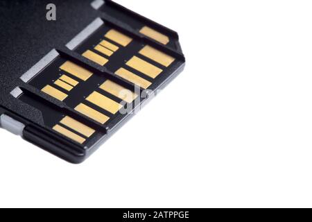 Selective focus photo of two rows of golden contacts on back of UHS-II high speed memory card isolated on white background close up. Fast modern memor Stock Photo