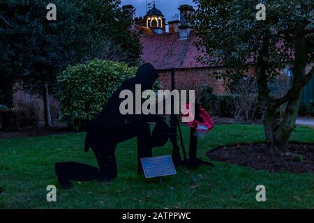 Abington Park, Northampton, the bell tower on the Museum lite up during the blue hour, pre dawn, a out of focus memorial to the service men how gave t Stock Photo