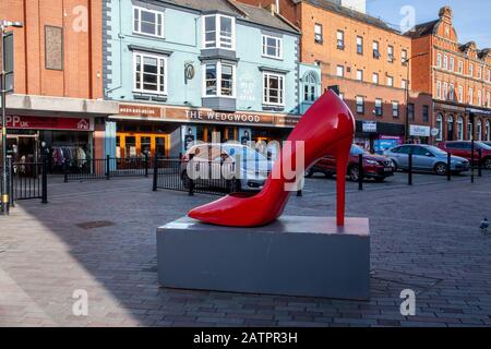 Northampton town centre a large scupture of a Red Stiletto in Abington Street. England, UK Stock Photo