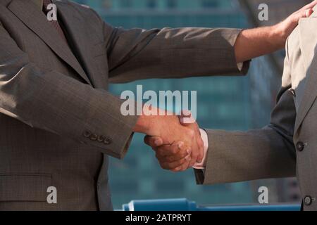 Businessmen shaking hands Stock Photo
