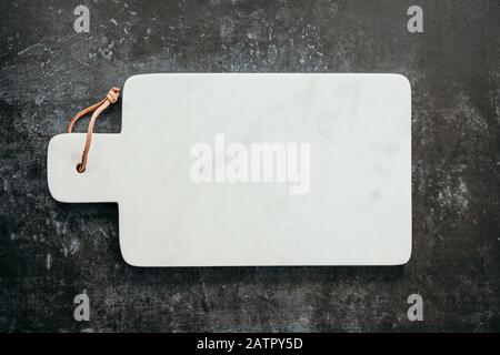 Top down view on an empty white marble cutting board. Stock Photo