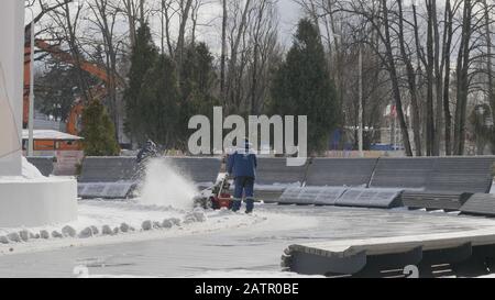 MOSCOW - December 20: Man using snow removal machine cleans snow in Moscow on December 20, 2018 in Moscow, Russia. Stock Photo