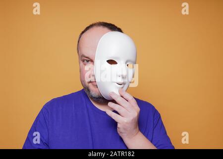 Man Holding a White Mask · Free Stock Photo