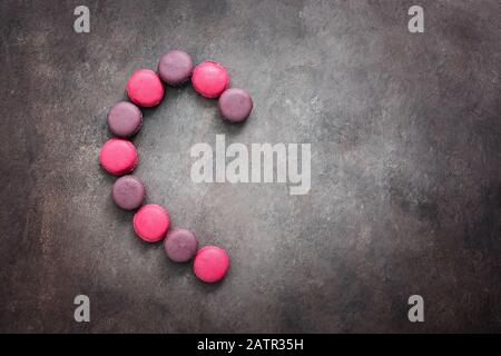 Half heart made of pink and purple macaroon on a dark background. Valentine's Day. Top view, lay Stock Photo - Alamy