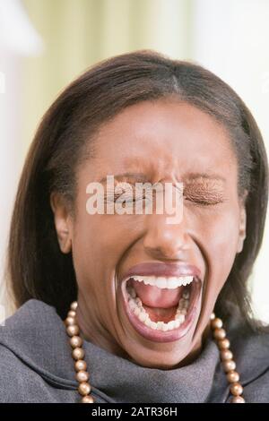 Close-up of a middle-aged woman screaming Stock Photo