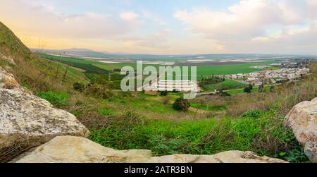Panoramic sunset view of landscape and countryside in the eastern part of the Jezreel Valley with Kibbutz Hefziba, Northern Israel Stock Photo