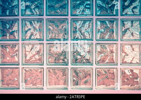 front view of glass blocks in a wall with original reflections Stock Photo