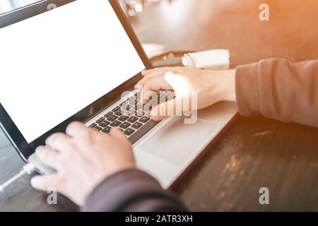 Freelancer working on computer keyboard at cafe Stock Photo
