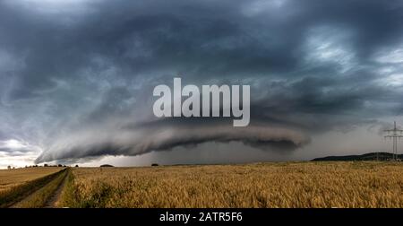 Beautiful supercell thunderstorm, daramtic clouds over the field