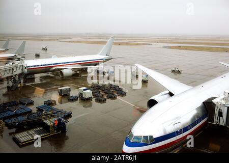 Airplanes being loaded up on the tarmac before takeoff. Stock Photo