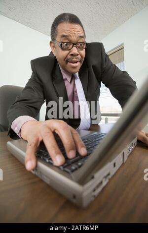 Businessman working on a laptop Stock Photo