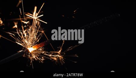 Firework festive sparkler burning on black background Stock Photo