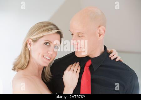 Mid adult woman dancing with a mid adult man and smiling Stock Photo