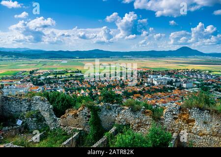 Landscape photo taken from the Rasnov Citadel showing the Rasnov city and the mountains in the distance - Rasnov, Brasov country, Transylvania, Romani Stock Photo