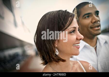 Smiling young woman standing next to her partner. Stock Photo