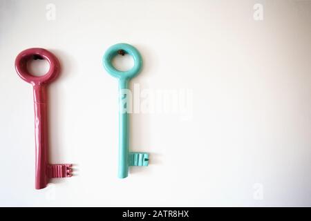 Metal key holder on light wall indoors Stock Photo