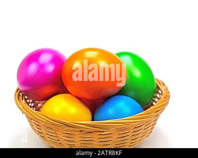 Colorful Easter eggs in basket against white background Stock Photo