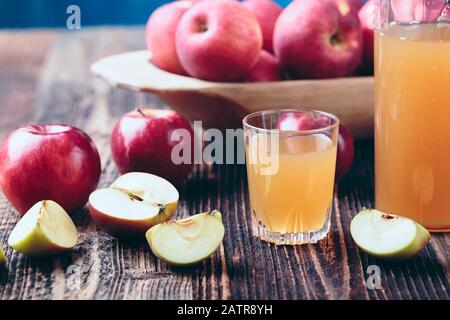 Fresh organic apple cider or apple juice on the old a wooden table. Stock Photo