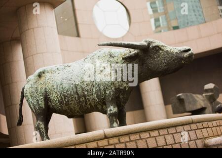 Statue of a horned bull outside a building in the city. Stock Photo