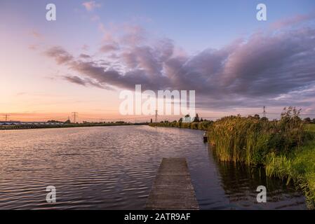 Beautiful image of sunset clouds over the water of river Rotte in The Netherlands Stock Photo