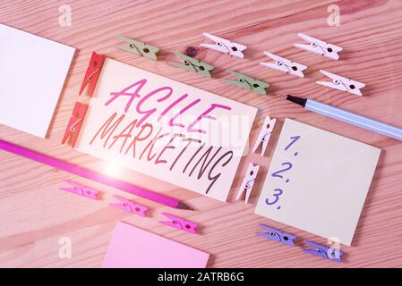 Word writing text Agile Marketing. Business photo showcasing focusing team efforts that deliver value to the endcustomer Colored clothespin papers emp Stock Photo