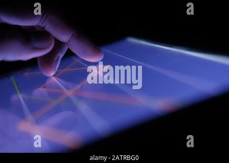Close up of man hand analyzing stock chart on digital tablet  Stock Photo