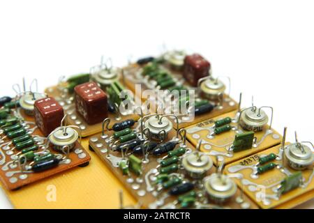 The old vintage circuit board with several electronic components. Stock Photo